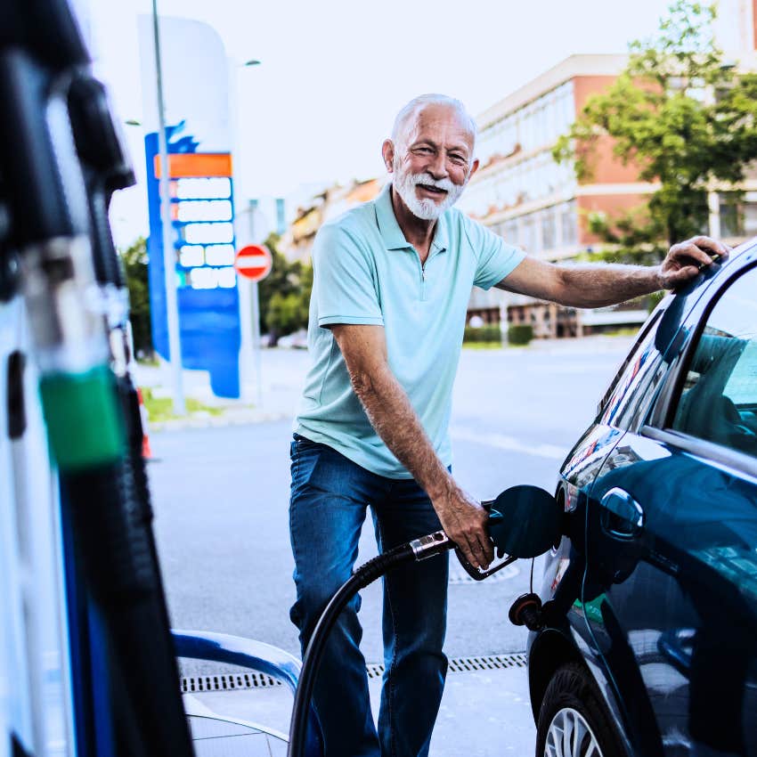 Baby boomer man paying for gas at the gas station.