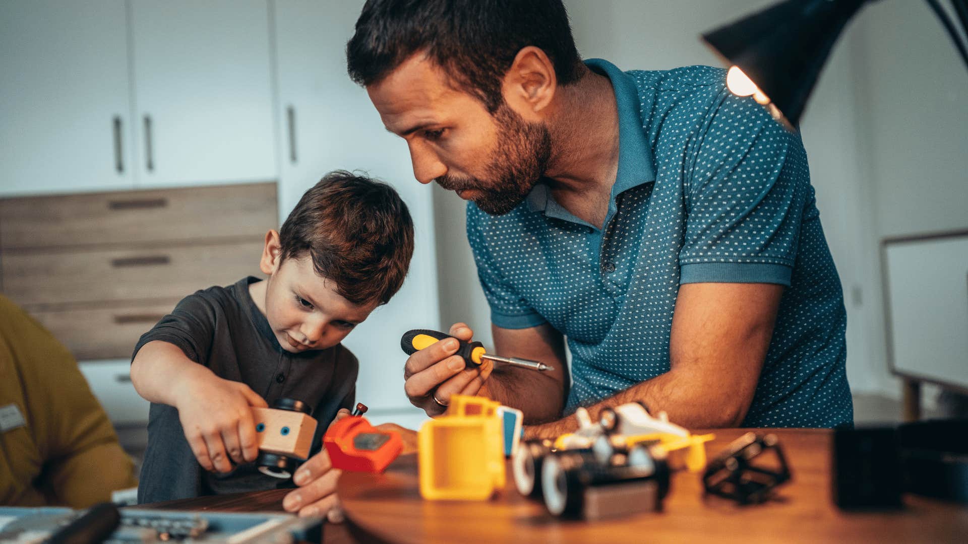 millennial man gentle parenting his son