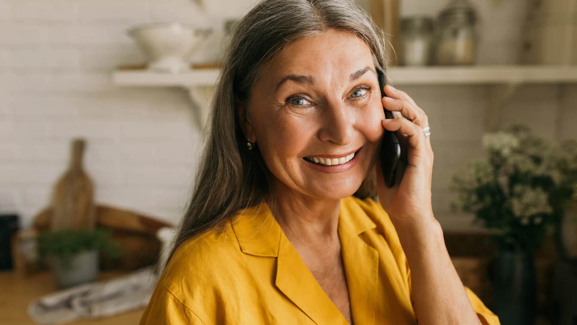 brilliant older woman speaking on phone asking how can i help