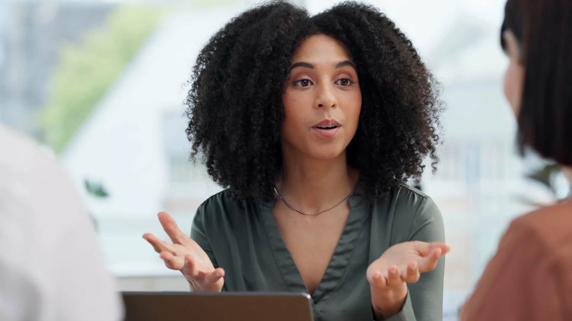 brilliant woman telling colleague tell me more about that