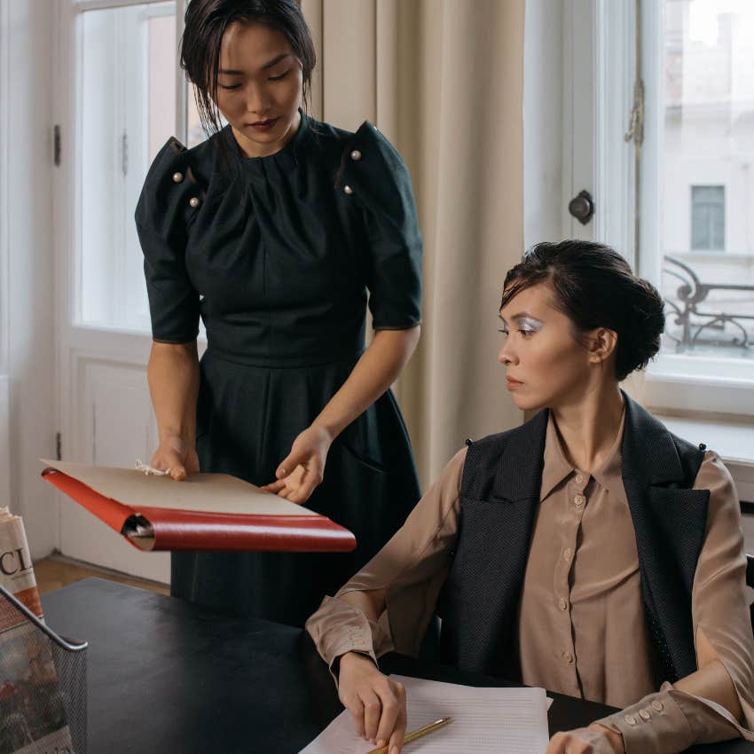 boss giving hardworking stressed employee more work