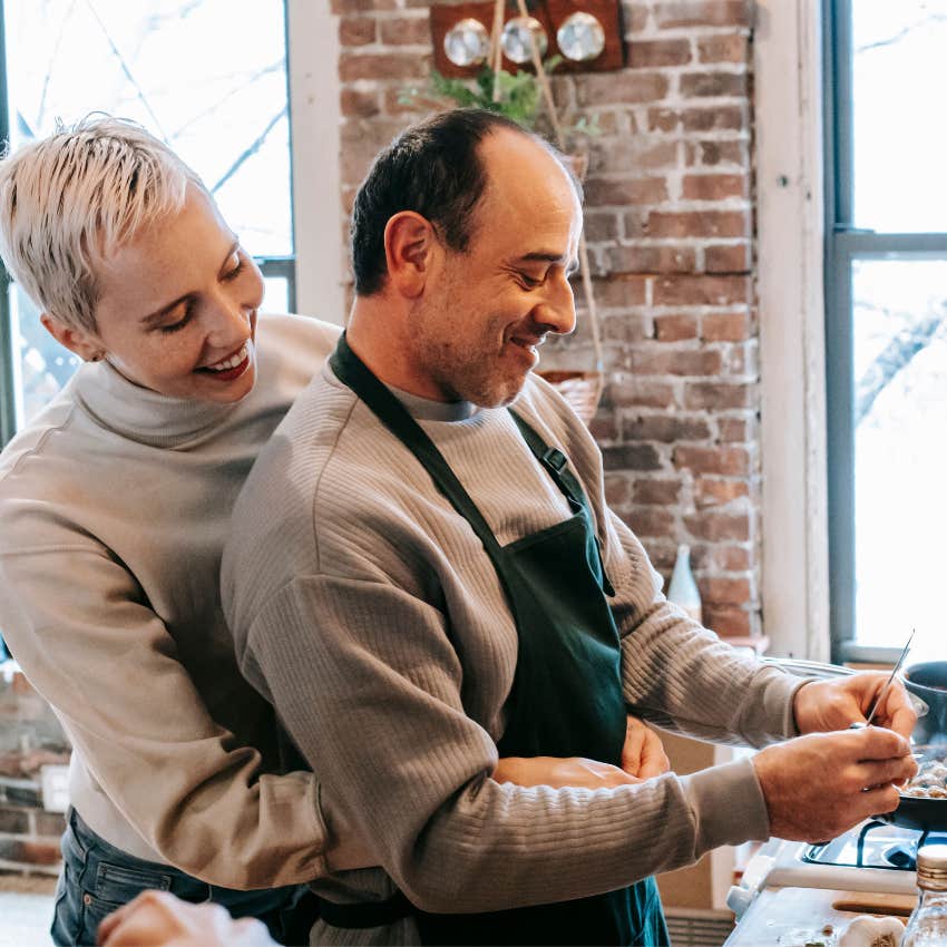 Long-term couple cooking a new recipe together in their kitchen while laughing and enjoying time together
