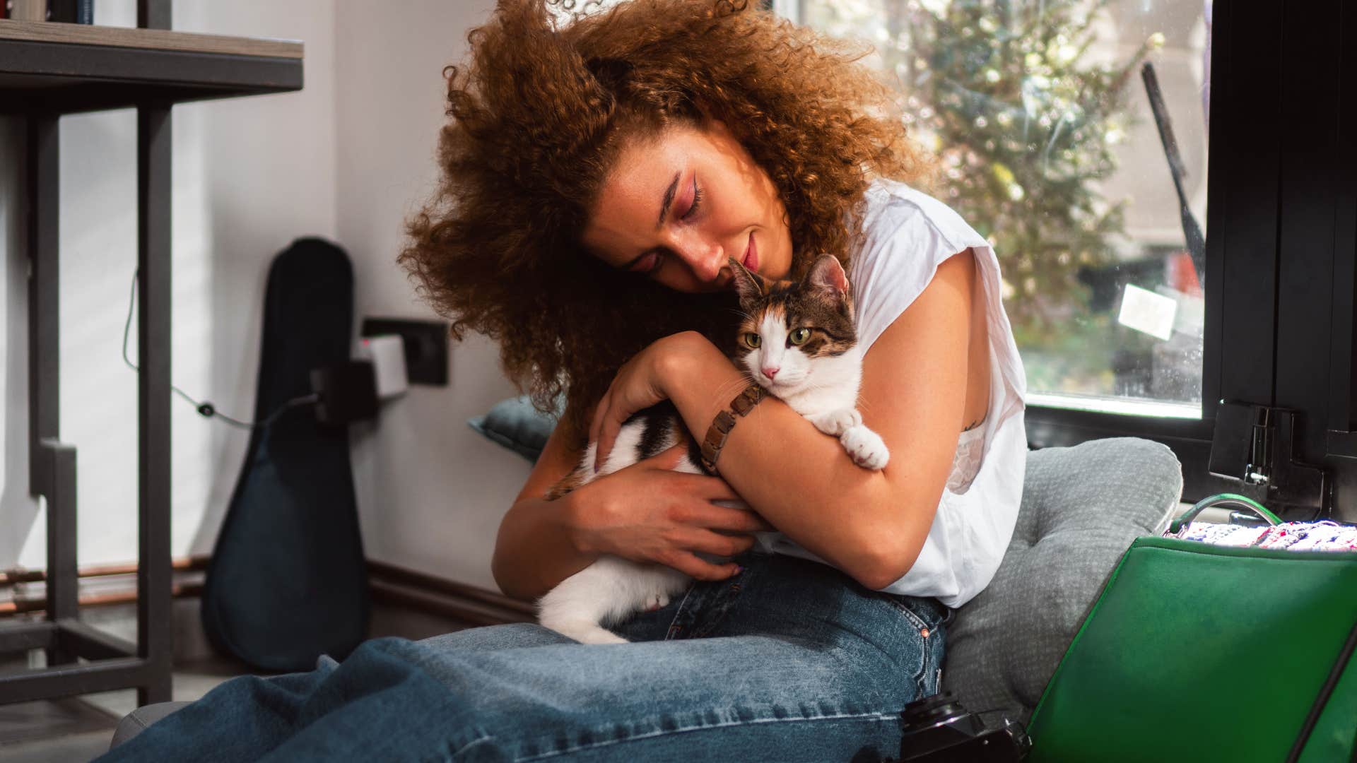woman keeps firm boundaries because she needs naps and quiet time to function snuggling her cat