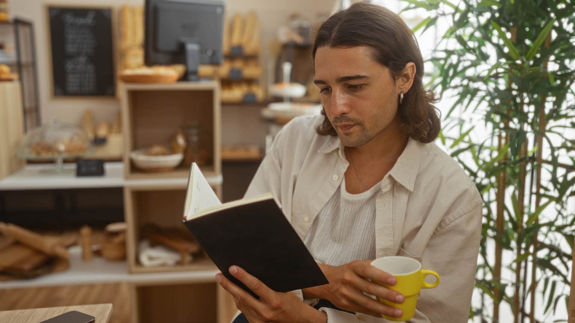 man who needs naps and quiet time to function reading for pleasure while drinking tea