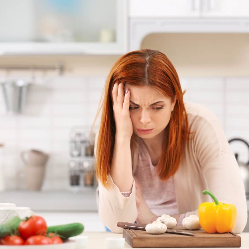 stressed woman cooking dinner after work