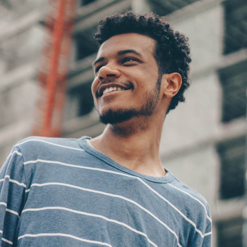stress-free man smiling by himself
