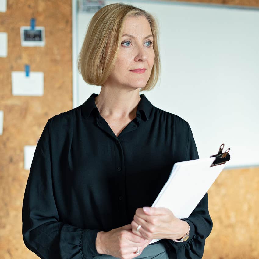 woman who is always early wanting a sense of control holding clipboard