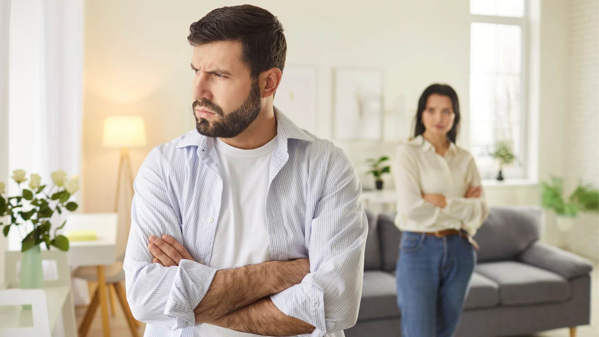 unhappy man turned away from woman saying you always blame me