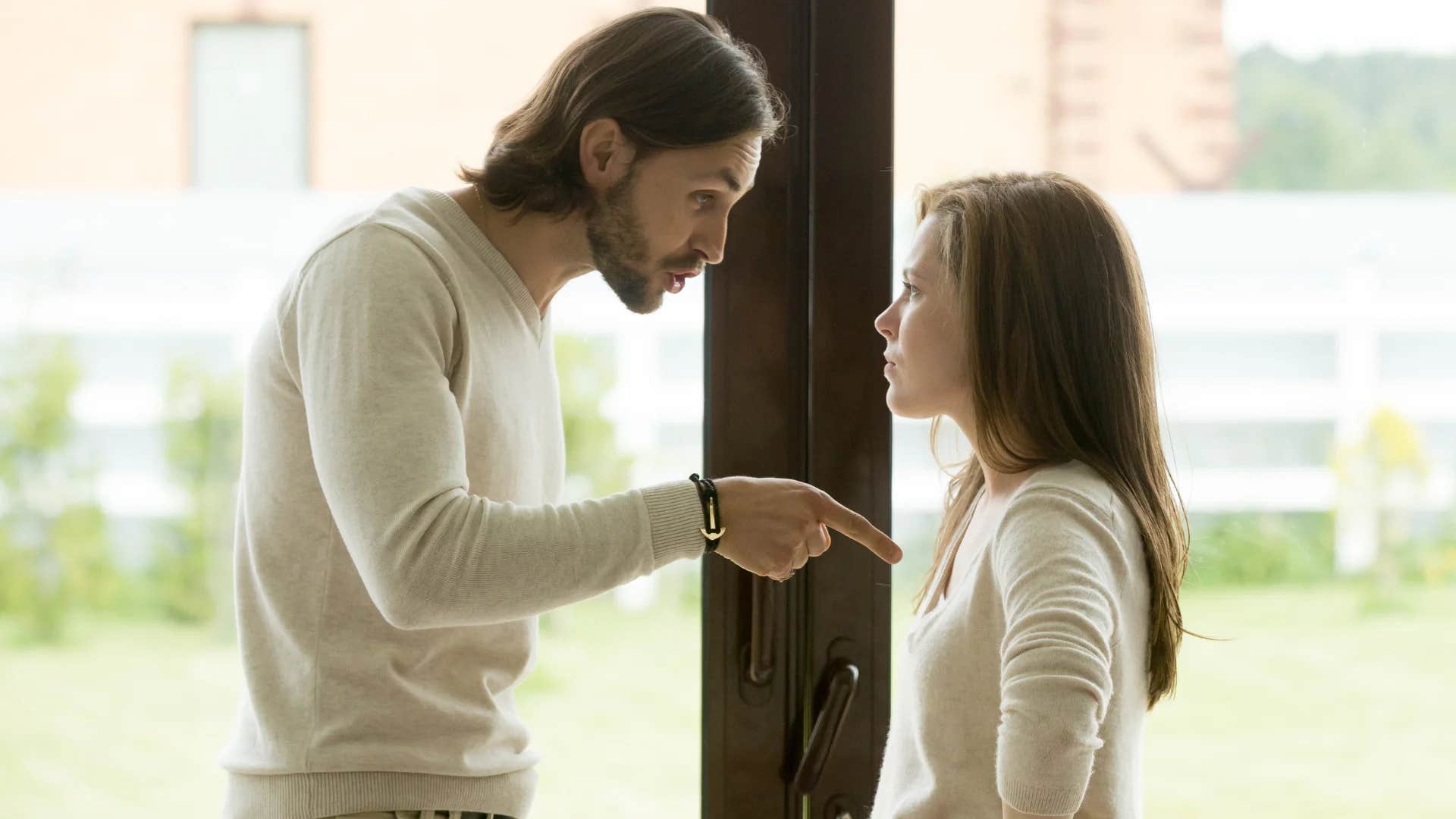 man confronting woman saying you never listen to me