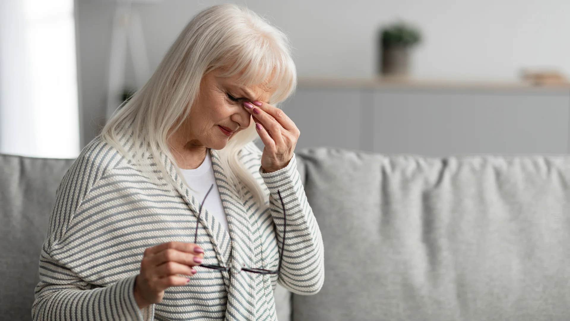 unhappy older woman saying i'm fine just tired