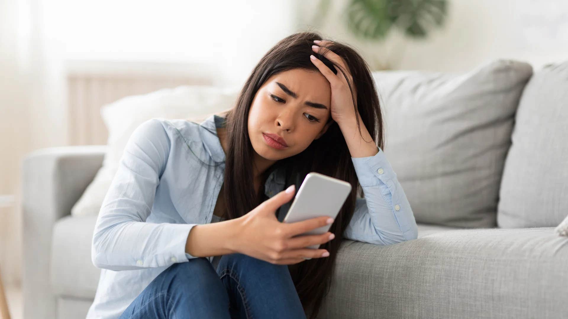 unhappy young woman thinking to herself nobody likes me