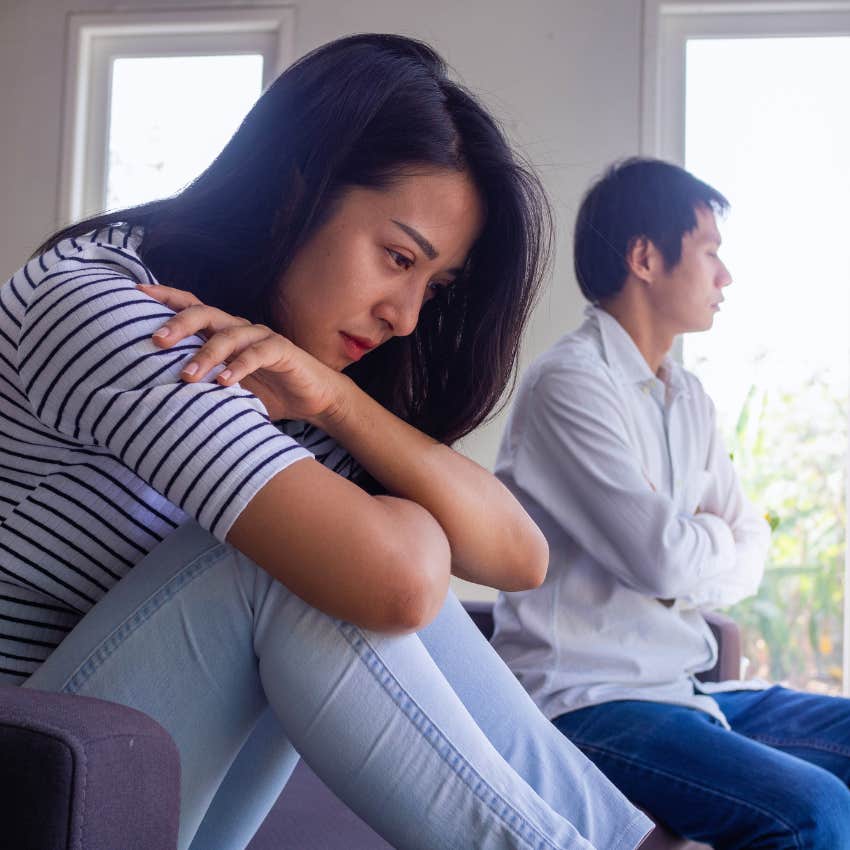 sad woman turned away from husband asking do you still love me