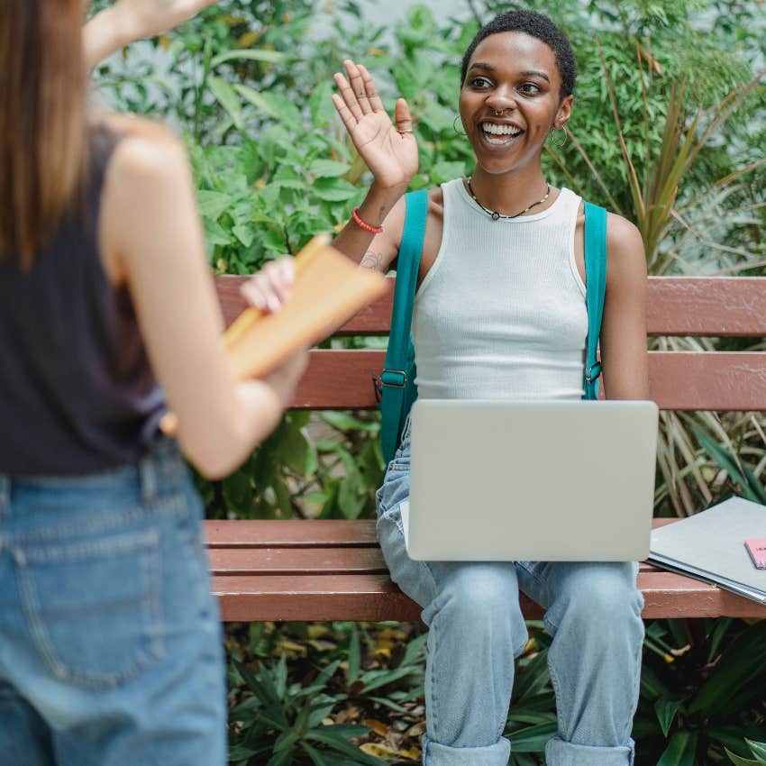 gen Z woman waving to friend impressed by her authenticity