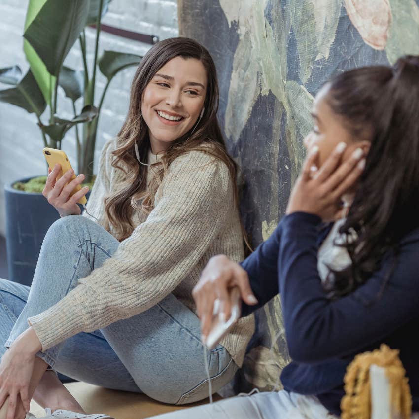 happy millennial woman impressed by communicative friend