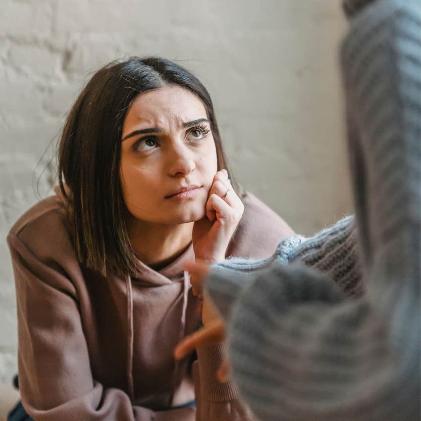 young woman carefully watching friend's mood in conversation
