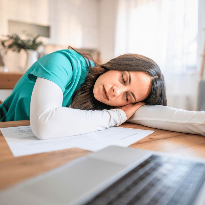 exhausted woman resting her head on her arm