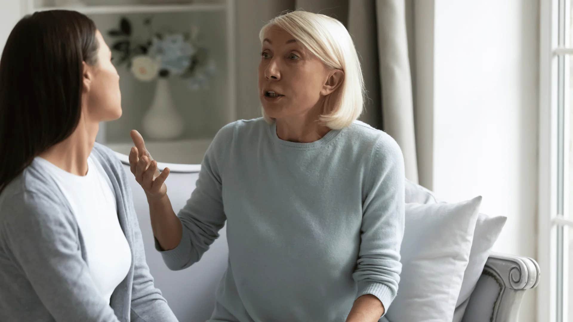 older woman telling younger woman that she'll give her something to cry about
