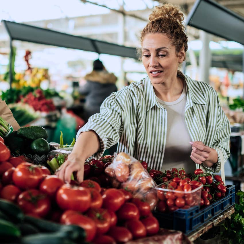 woman shopping for the lowest price at the grocery store