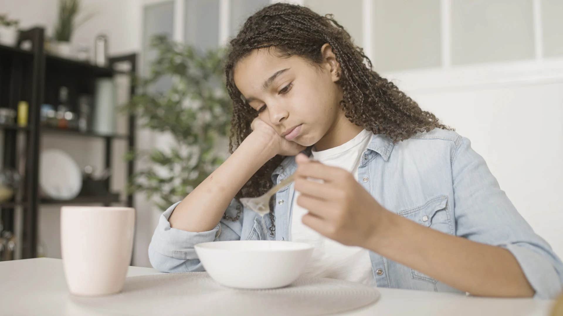 teenage girl being told finish your food