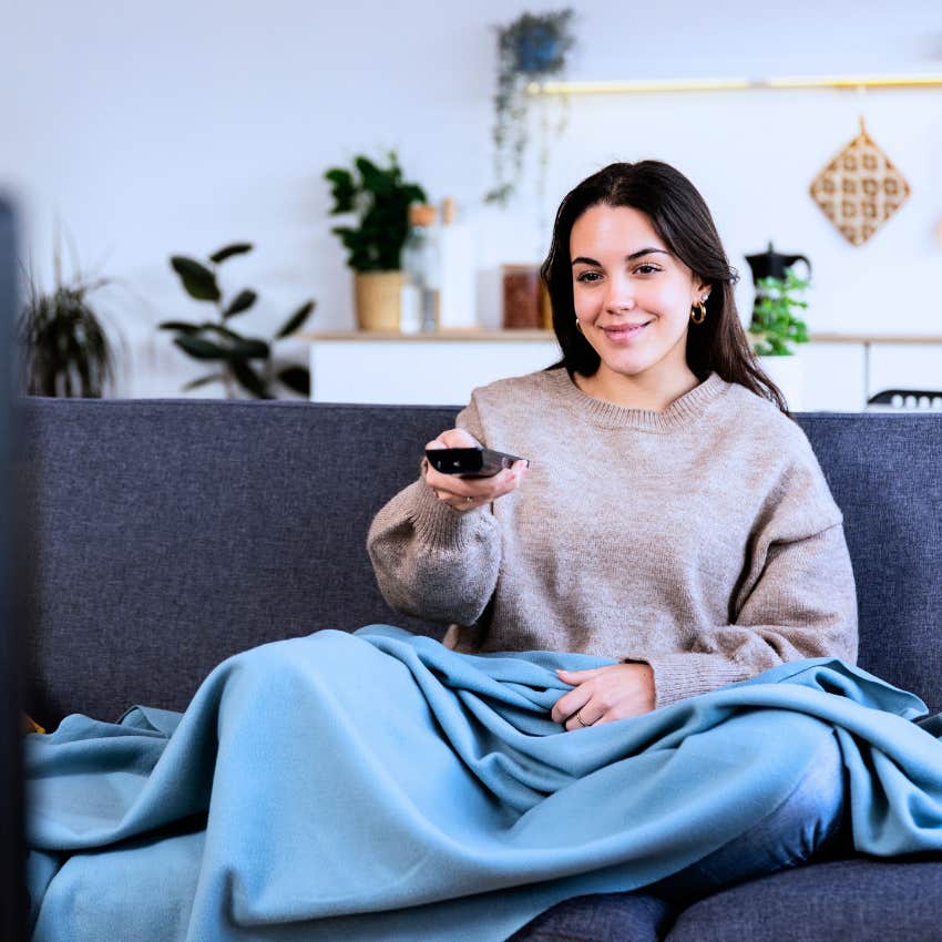 Gen Z woman refusing social invite to relax at home watching tv
