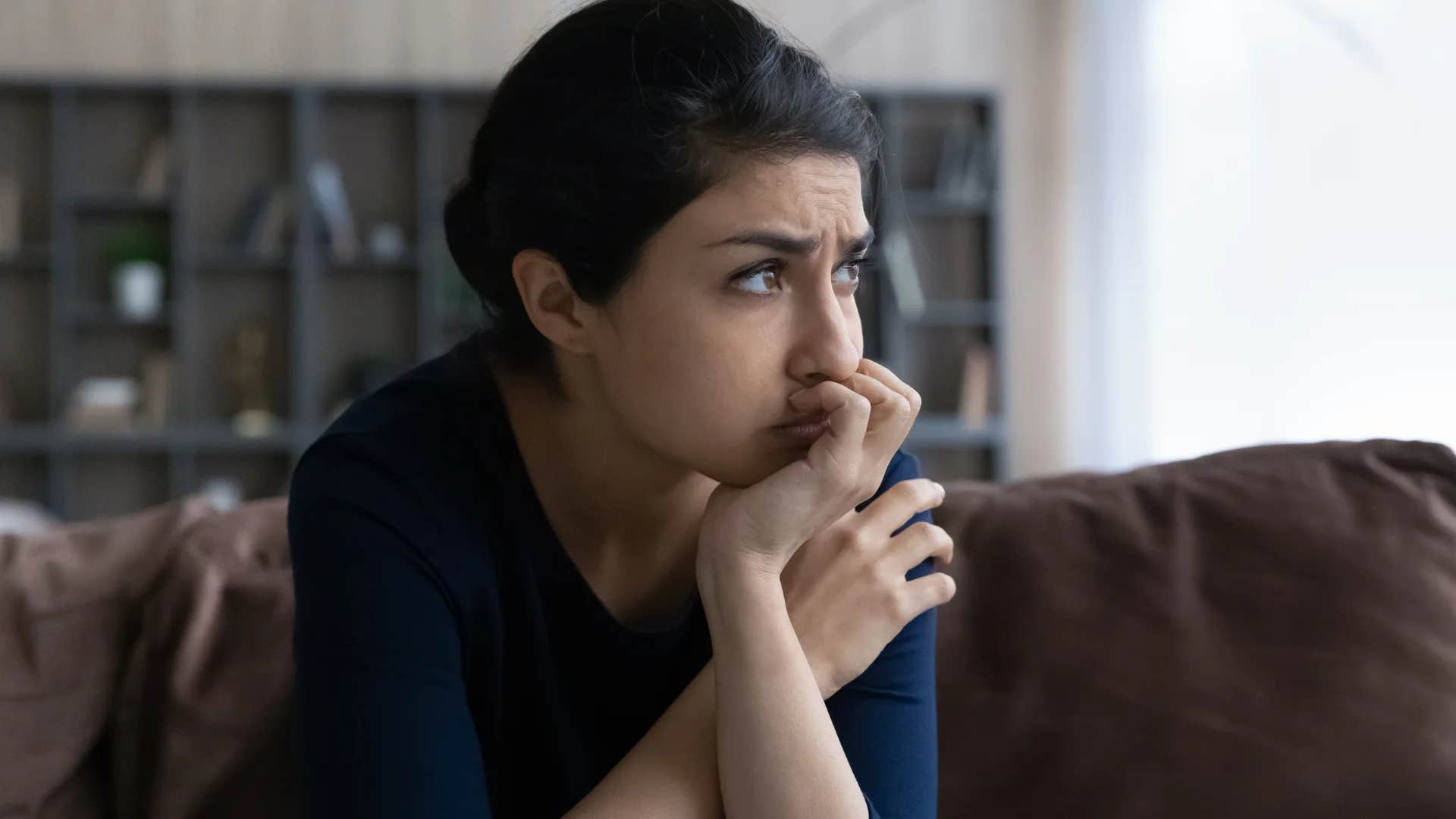 stressed out Gen Z woman thinking about financial investments being a waste