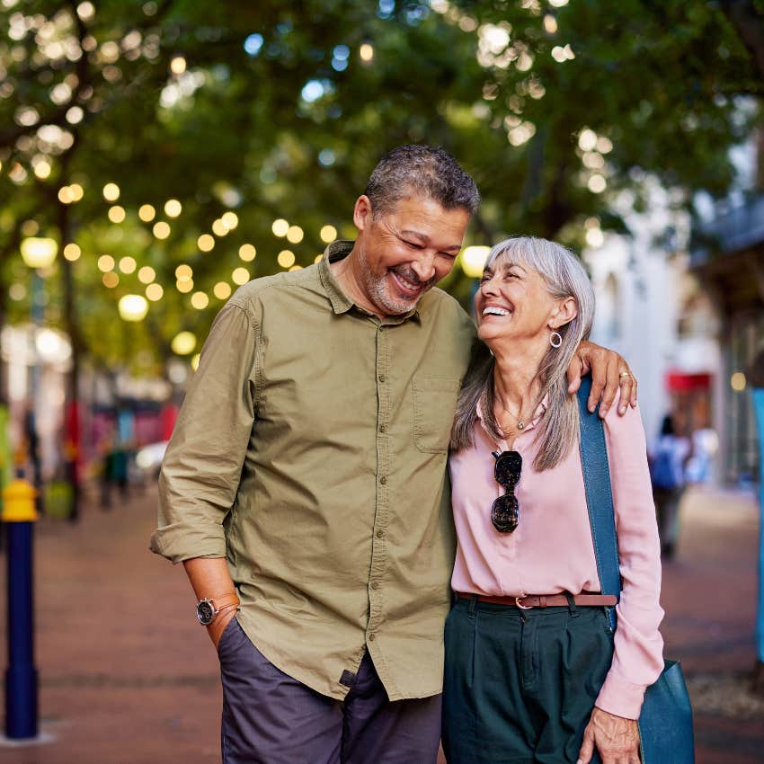 attractive older man with arm around woman moves at a slower calm pace in life