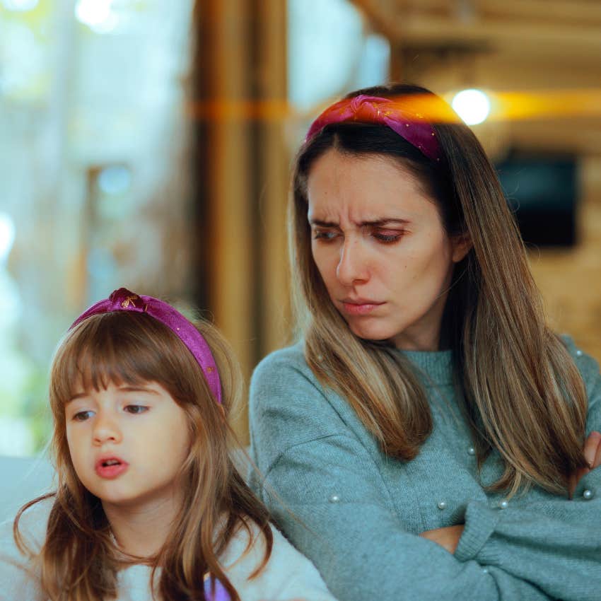 emotionally immature mom with arms crossed looking at her daughter with jealousy