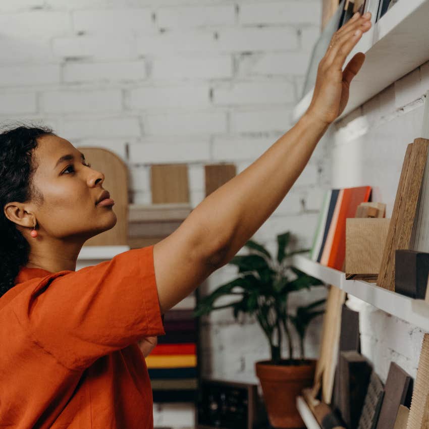 woman who prioritizes tidiness organizing her shelves at home