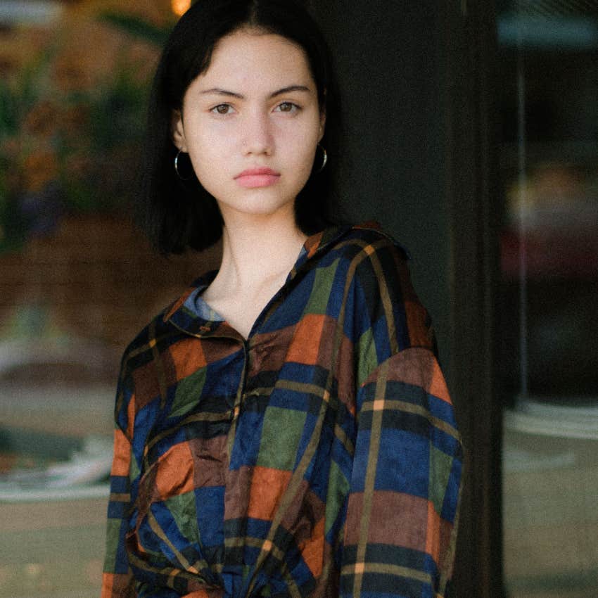 serious independent woman standing outside alone