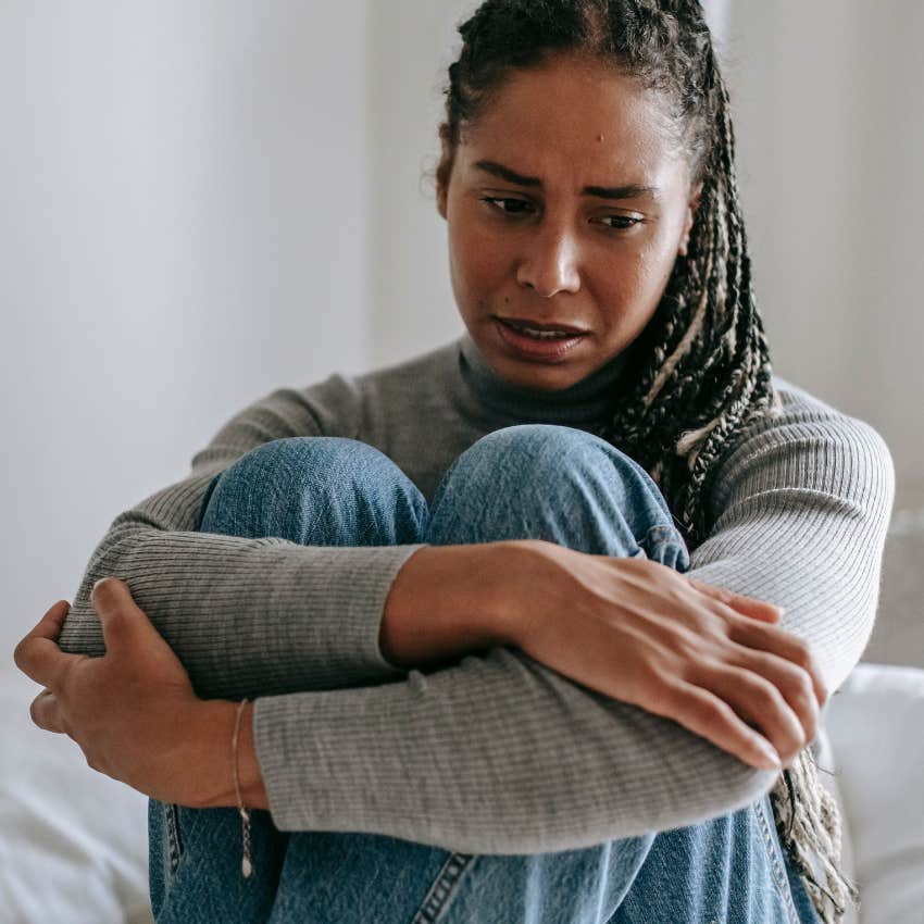 sad woman deeply worried alone at home