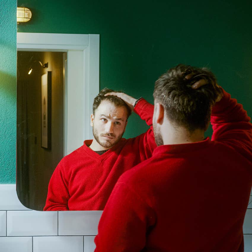 insecure man looking in mirror was raised by anxious parents