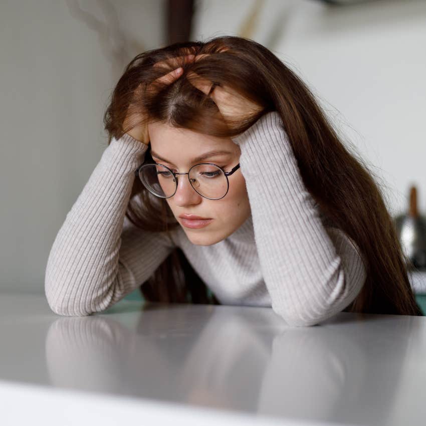 woman with hands in hair who was raised by anxious parents overthinking everything