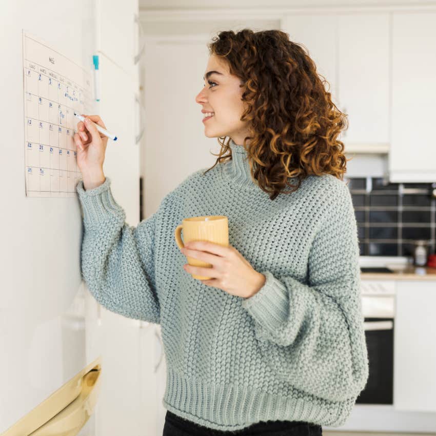 woman raised by anxious parents checking her calendar because she loves her routine