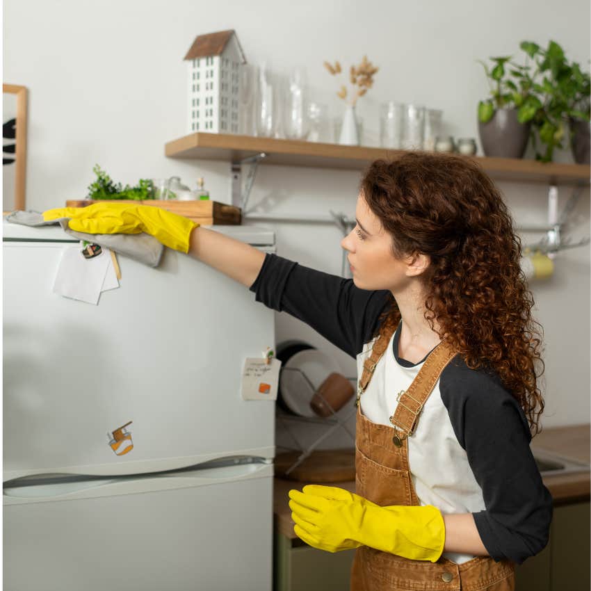 woman who became a clean freak washing the top of her refrigerator because she was raised in a dirty house