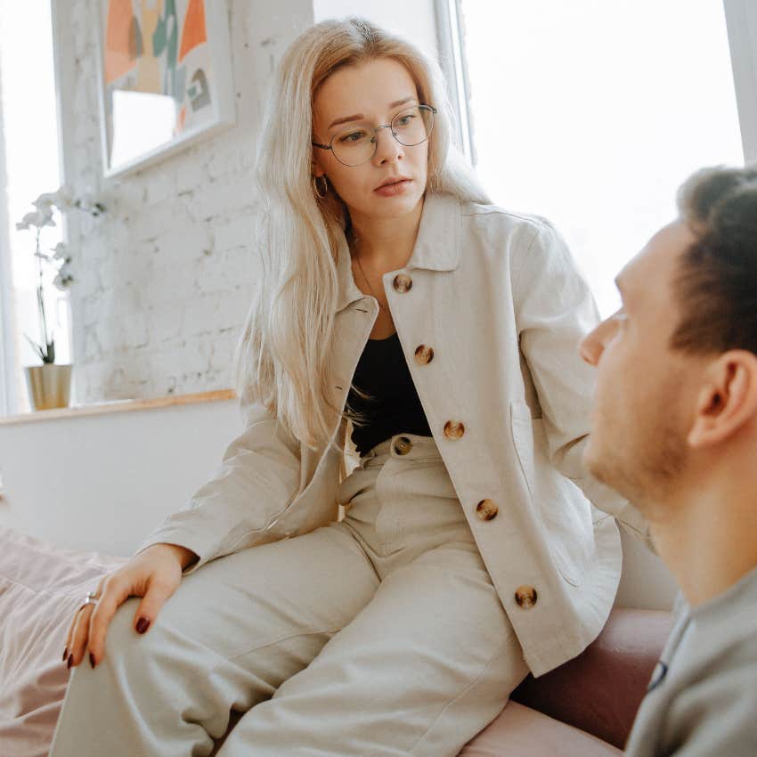 woman talking to partner hiding her emotions with a serious face