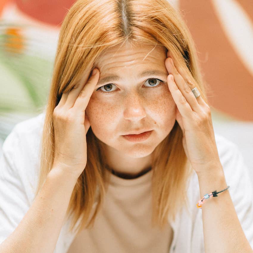highly anxious woman looking worried by herself