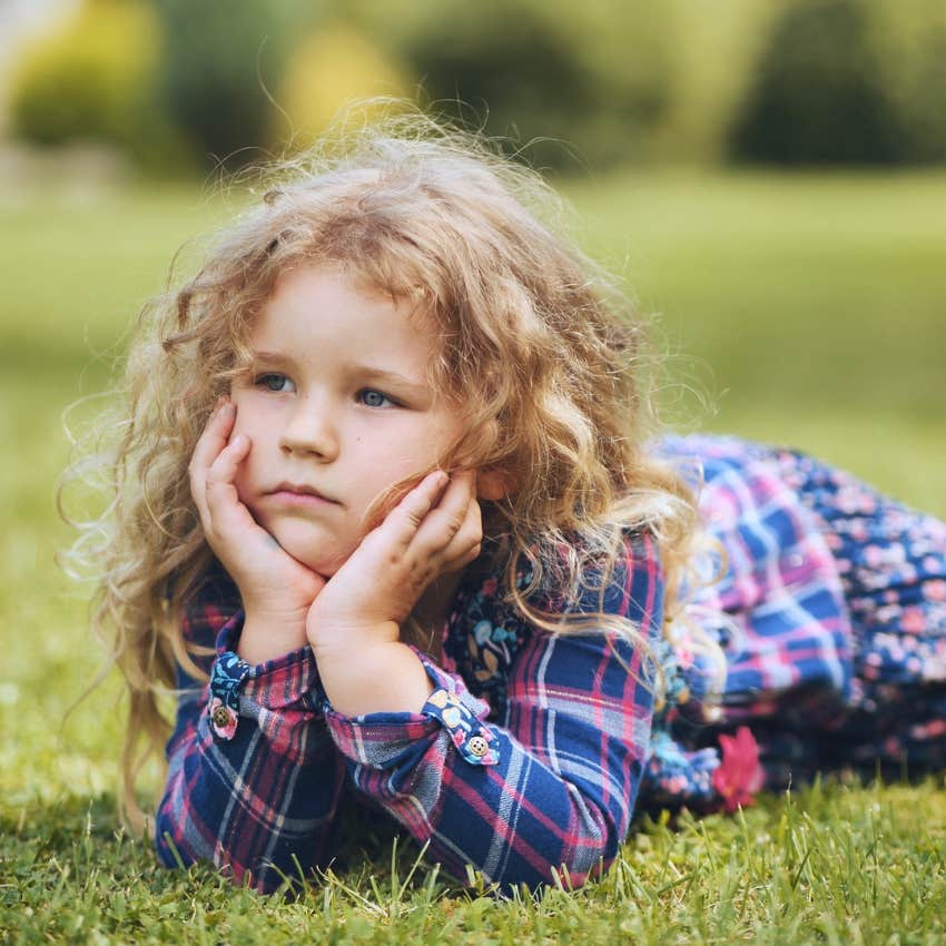little girl lying on grass raised with too many choices avoids making decisions
