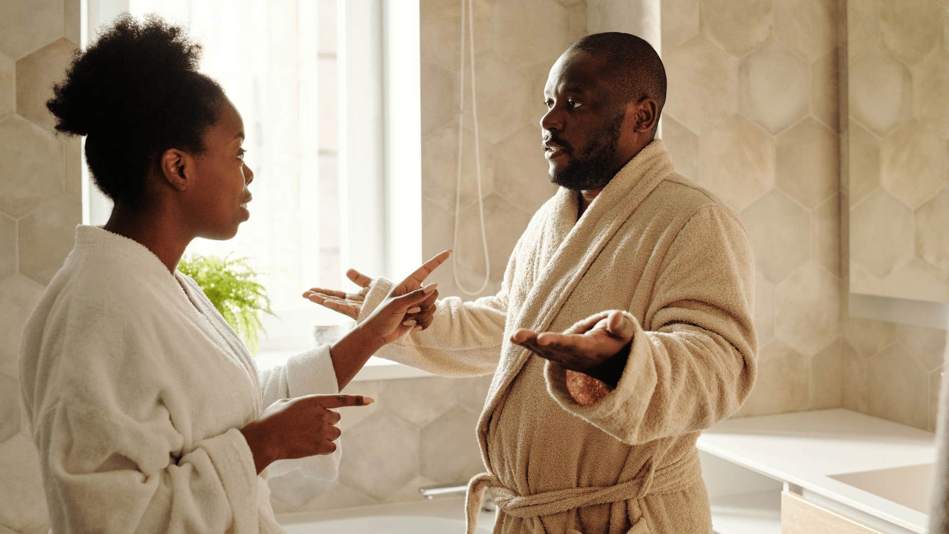 man getting defensive with wife at home