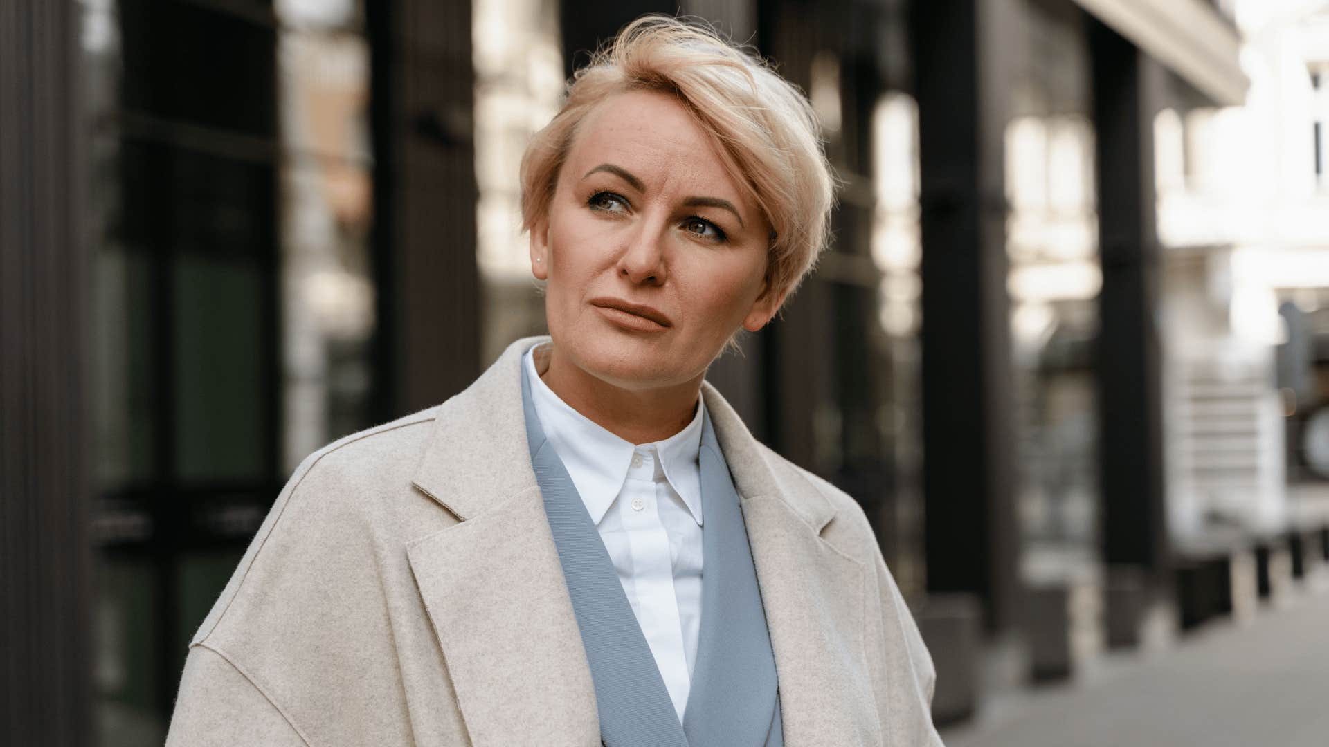 older woman feeling unconfident as a result of her upbringing