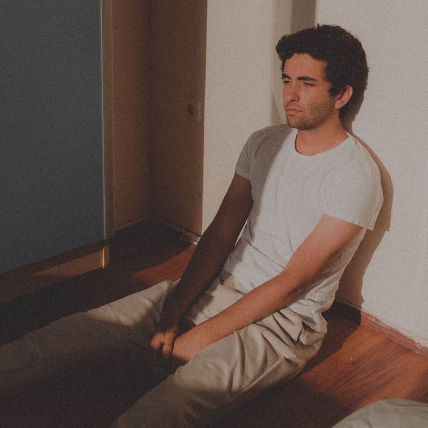tired man sitting home alone after socializing