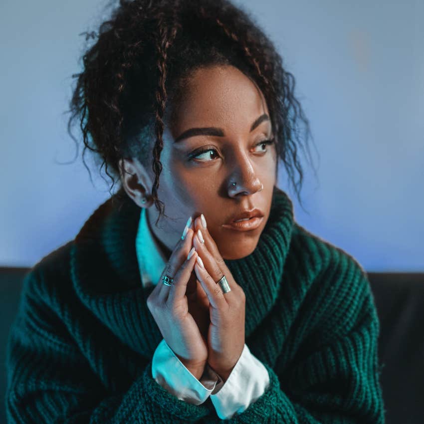 quiet woman sitting in silence at home alone