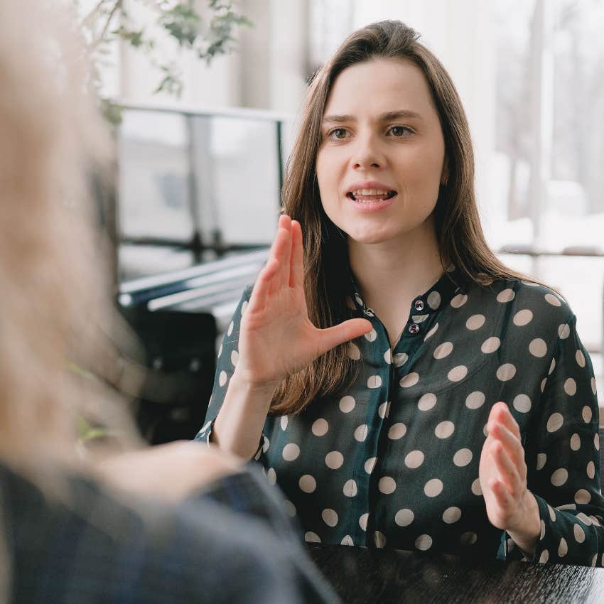 woman ignoring her friend who is offering her help