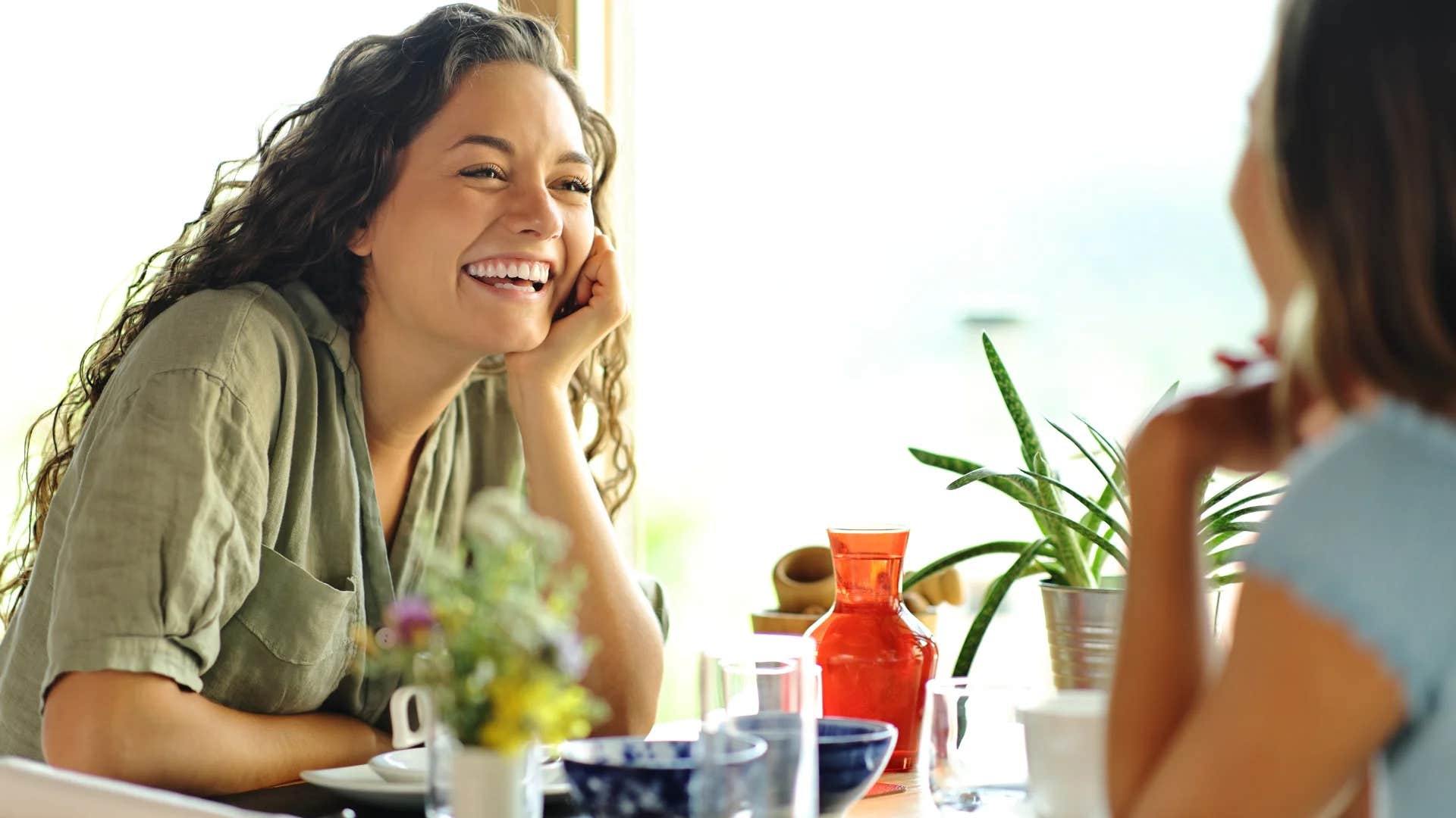 woman trying hard to impress friend by acting overly extroverted