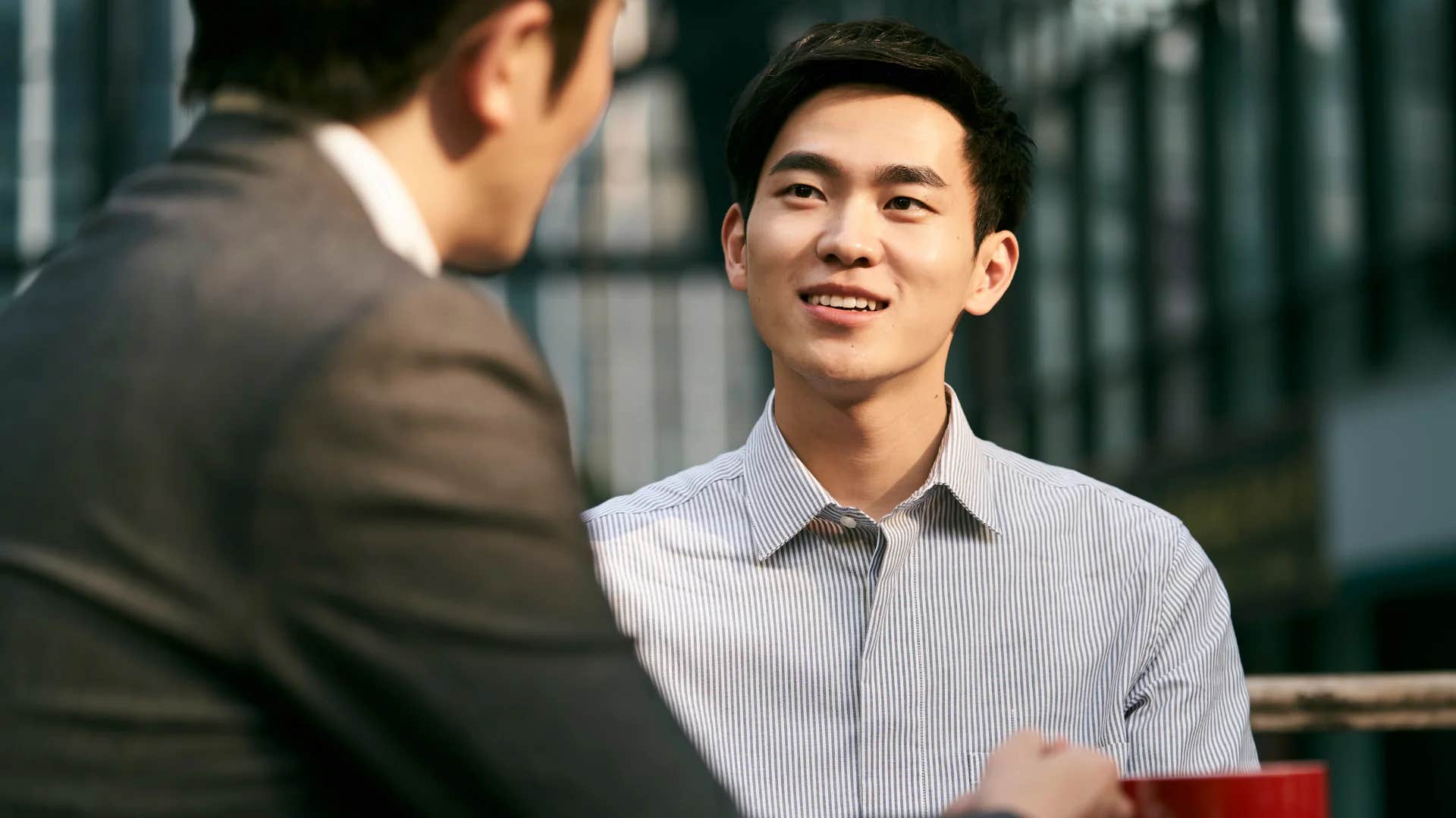 man enjoying talking about himself while trying to impress colleague