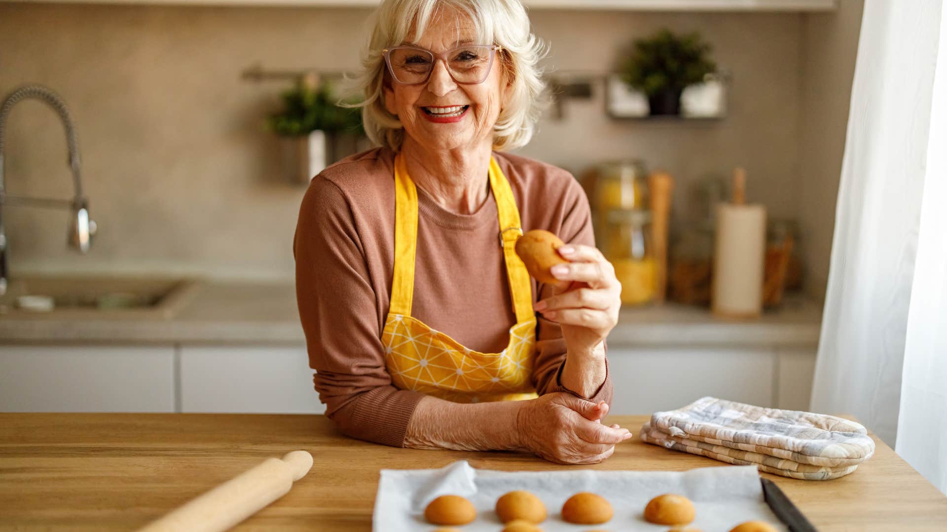 retired introvert woman happily baking cookies