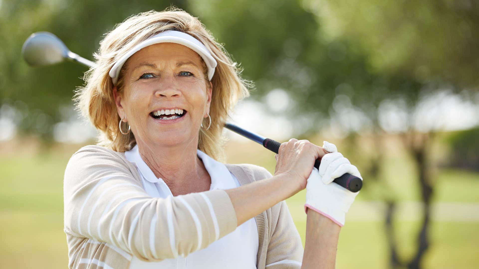 retired introvert woman happily playing a round of golf