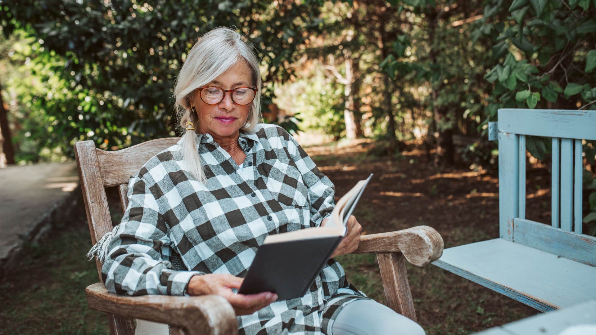 introvert retired woman happily reading a good book