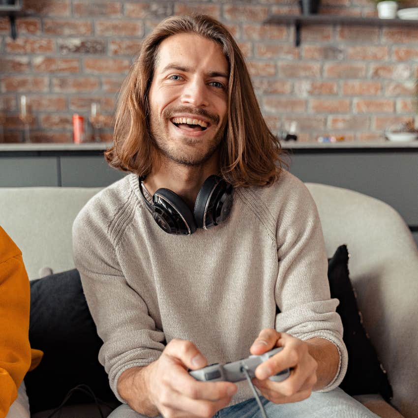 happy man playing video games at home