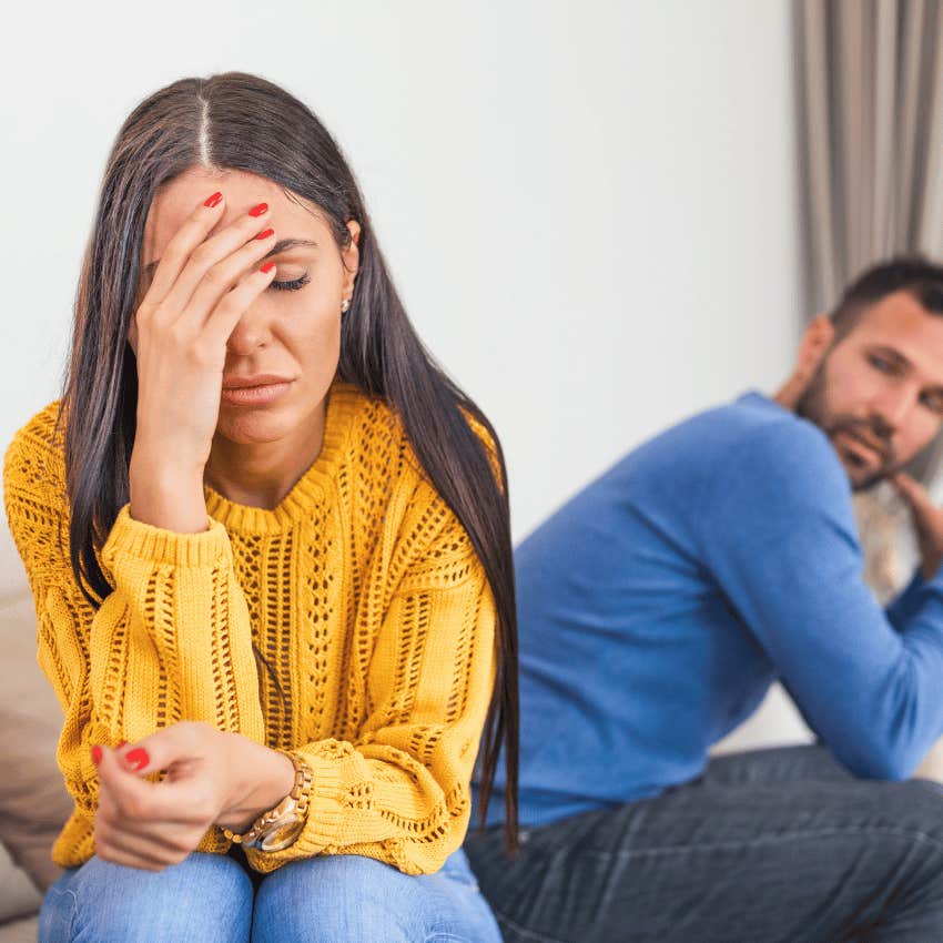 hurt woman turned away from man