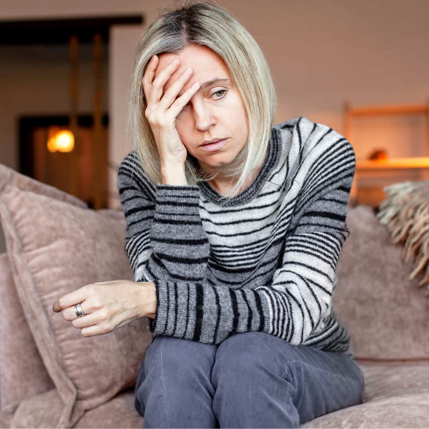 sad woman hiding her emotions and feeling overwhelmed at home
